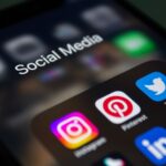 A phone showing popular social media apps