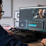 AI Content, Video And Visuals A video editor working at a desktop in an office