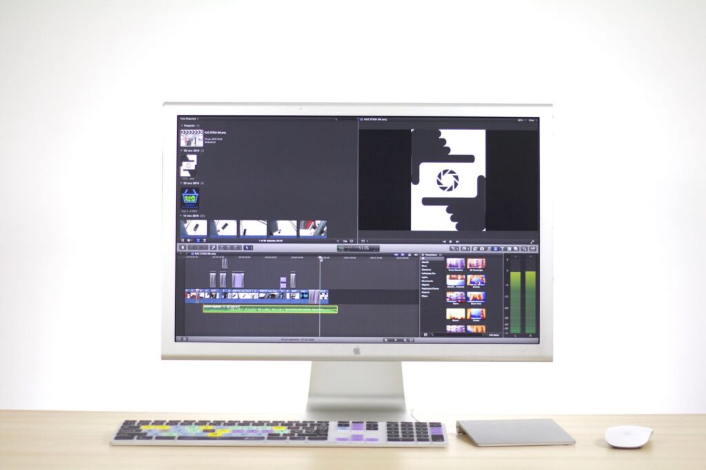 Video editing software open on an iMac in a bright workspace