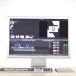 AI Content, Video And Visuals Video editing software open on an iMac in a bright workspace