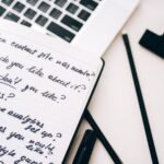 Content Marketing & Management Planning content in a notebook beside a laptop